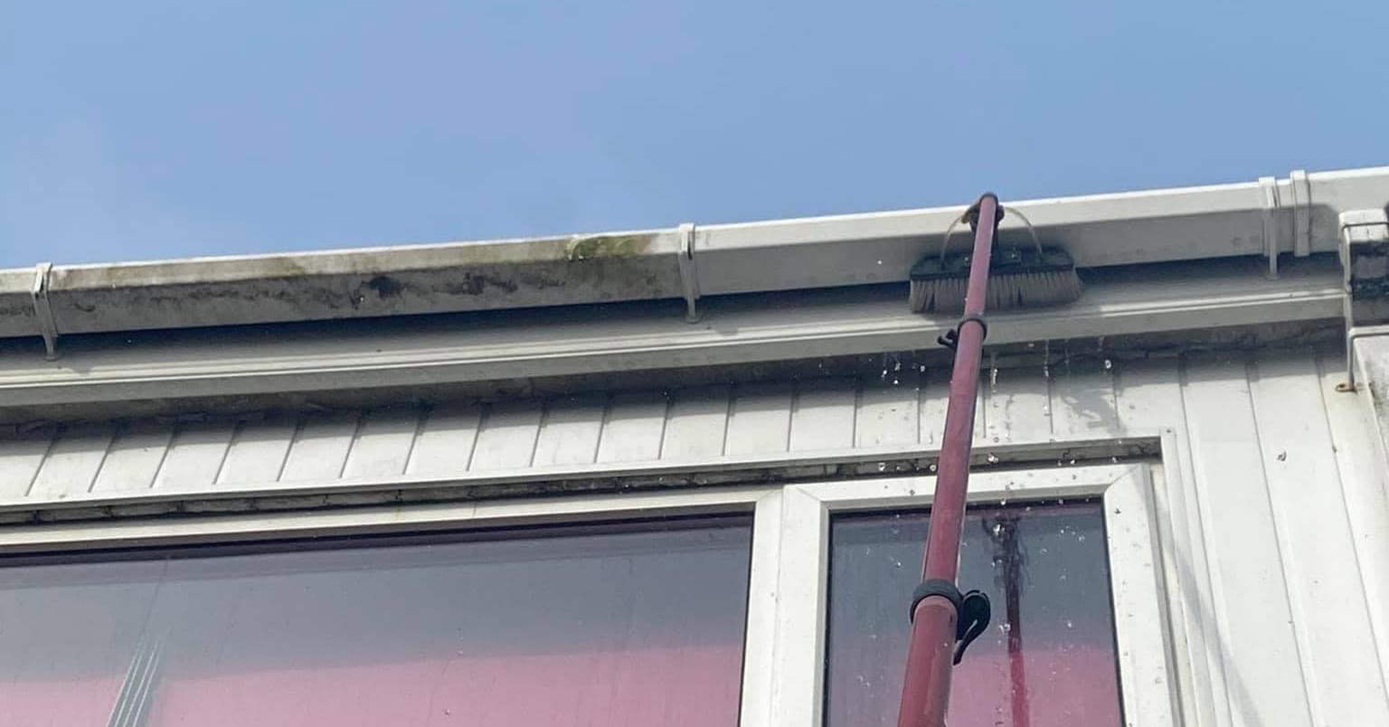 uPVC in process of cleaning gutter drain by Sparkly Clean